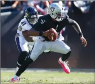  ?? NHAT V. MEYER/TRIBUNE NEWS SERVICE ?? Oakland Raiders quarterbac­k EJ Manuel (3) is sacked by the Ravens' Anthony Levine Sr. (41) in Oakland on Sunday.