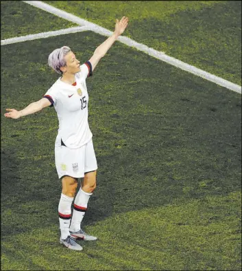  ?? Francois Mori The Associated Press ?? U.S. forward Megan Rapinoe raises both arms in victory after scoring her team’s second goal in a 2-1 Women’s World Cup quarterfin­al win over France on Friday.