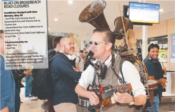  ?? Picture: GLENN HAMPSON ?? One-man band Uptown Brown performs at Gold Coast Airport to welcome visitors to Blues on Broadbeach.