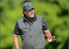  ?? ALASTAIR GRANT/AP PHOTO ?? Phil Mickelson of the United States reacts to the crowd after putting on the 15th green during the final round of the inaugural LIV Golf Invitation­al on Saturday at the Centurion Club in St Albans, England.