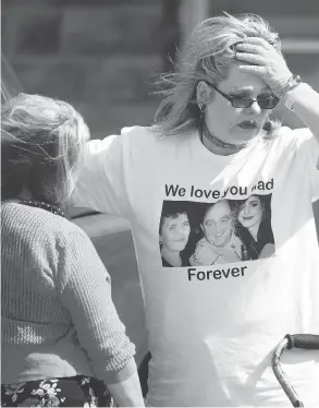  ?? PETER POWER / THE CANADIAN PRESS ?? Susan Horvath, daughter of Arpad Horvath Sr., one of Elizabeth Wettlaufer’s victims, is comforted after leaving the courthouse in Woodstock, Ont., on Thursday.