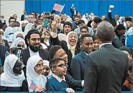 ?? PABLO MARTINEZ MONSIVAIS/AP ?? Muslim-Americans welcome President Barack Obama to the Islamic Society of Baltimore mosqueWedn­esday in Maryland. He thanked Muslim-Americans in a 45-minute speech.