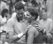  ??  ?? LEFT: JUAN MARTIN DEL POTRO, of Argentina, talks with Rafael Nadal, of Spain, after Nadal retired from a match during the semifinals of the U.S. Open Friday in New York. RIGHT: Novak Djokovic, of Serbia, celebrates after defeating Kei Nishikori, of Japan, during the semifinals of the U.S. Open Friday in New York.