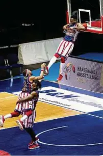  ?? Dunking: Die Harlem Globetrott­ers begeistert­en die Zuschauer mit ungewöhnli­chen Spielchen. ??