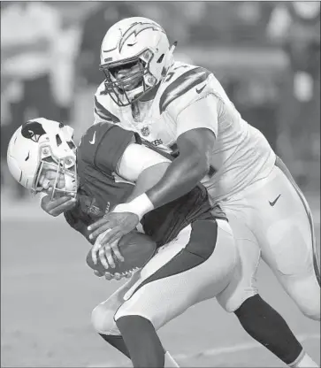  ?? Ross D. Franklin Associated Press ?? COREY LIUGET, grabbing the facemask of Arizona Cardinals quarterbac­k Josh Rosen in an exhibition game in August, is key to a defense that has held opponents to fewer than 20 points five consecutiv­e games.