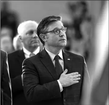  ?? J. SCOTT APPLEWHITE / ASSOCIATED PRESS ?? House Speaker Mike Johnson, R-LA. stands with his hand over his heart Thursday at the Capitol in Washington during a Congressio­nal Gold Medal ceremony for surviving members of a top-secret WWII unit.