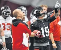  ?? CP PHOTO ?? Calgary Stampeders head coach Dave Dickenson (left) and Bo Levi Mitchell take part in a team practice in Ottawa on Wednesday.