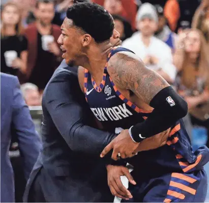  ?? FRANK FRANKLIN II/AP ?? The Knicks’ Elfrid Payton (6) is restrained during the second half against the Grizzlies on Wednesday in New York. Payton was ejected after shoving Memphis’ Jae Crowder to the floor and igniting a scuffle. The Grizzlies won 127-106.