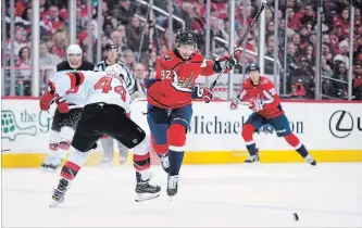  ?? NICK WASS
THE ASSOCIATED PRESS ?? Capitals centre Evgeny Kuznetsov chases the puck next to New Jersey Devils left-winger Miles Wood (44) on Saturday in Washington.