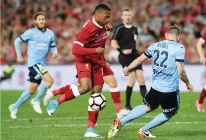  ?? — AFP ?? SYDNEY: Liverpool’s Daniel Sturridge (C) fights for ball with Sydney FC player Sebastian Ryall during their end-of-season friendly football match at the Olympic Stadium in Sydney yesterday.