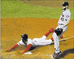  ?? David J. Phillip ?? The Associated Press Red Sox right fielder Mookie Betts scores by Astros pitcher Lance Mccullers Jr. on a passed ball during the seventh inning Sunday in Boston.