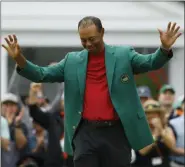  ?? MATT SLOCUM - THE ASSOCIATED PRESS ?? In this April 14, 2019, file photo, Tiger Woods smiles as he wears his green jacket after winning the Masters golf tournament in Augusta, Ga.