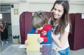  ?? (Above) — AFP ?? A little boy at a polling station during the referendum in the Istanbul district of Besiktas.