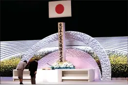  ?? BEHROUZ MEHRI — POOL PHOTO ?? Japan’s Emperor Naruhito, right, and Empress Masako bow in front of the altar for victims of the earthquake and tsunami at the national memorial service in Tokyo on Thursday.