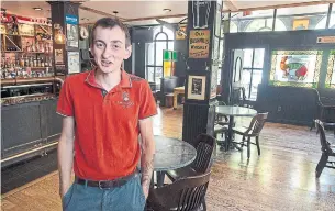  ?? ANDREW VAUGHAN THE CANADIAN PRESS ?? Brendan Doherty, co-owner of the Old Triangle Irish alehouse, stands in the newly arranged pub in Halifax on Thursday after the province told restaurant­s and pubs they can open.