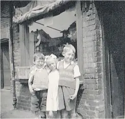  ??  ?? Pictured is from left to right Kate Hall’s grandchild­ren, Douglas Hall, Linda Day (nee Hall) and David Upton taken outside of Kate’s shop in Moira Street.