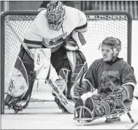  ?? CP PHOTO ?? Humboldt Broncos bus crash survivor Ryan Straschnit­zki, right, plays in a fundraisin­g sledge hockey game in Calgary on Sept. 15.