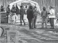  ?? ALLEN MCINNIS/POSTMEDIA NEWS ?? The Mohawks of Kahnawake continue their blockade of the CP Rail lines south of Montreal on Wednesday.