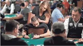  ?? AP ?? Lana Brey gives a massage to Viliyan Petleshkov during a tournament at the World Series of Poker in Las Vegas on June 8.