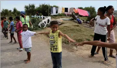  ??  ?? Children practise social distancing while the spread of the coronaviru­s disease (Covid-19) continues, in an informal settlement in Cape Town, South Africa, yesterday.