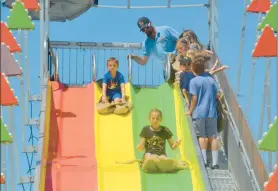  ?? AMANDA HAVERSTICK/AP ?? Children make their way down a giant sliding board at 2022’s La Porte County Fair. 2023’s La Porte County Fair continues through July 15.