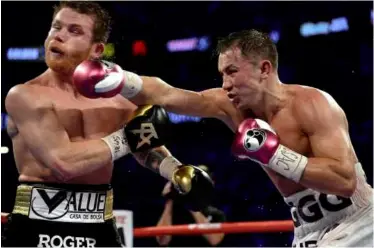  ?? Photos: JOE CAMPOREALE/USA TODAY SPORTS ?? STRONG: Golovkin dashes a powerful cross into Canelo’s jaw