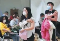  ?? ZOU HONG / CHINA DAILY ?? Employees of internet giant Tencent receive COVID-19 vaccinatio­ns at their workplace in Beijing on Monday.