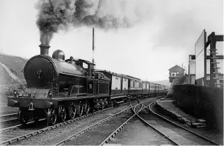  ??  ?? LNWR ‘Experiment’ No. 1357 City of Edinburgh mounts Shap Summit with the 10am from Euston to Glasgow Central. R J PURVES/RM ARCHIVE