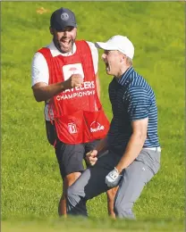  ?? Associated Press photo ?? Jordan Spieth celebrates with caddy Michael Greller after sinking a shot from a bunker on the first playoff hole during the final round of the Travelers Championsh­ip golf tournament, Sunday in Cromwell, Conn.