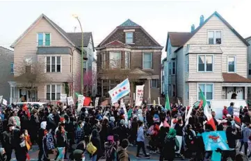  ?? JOHN J .KIM/CHICAGO TRIBUNE ?? Protesters march to remember 13-year-old Adam Toledo on West Diversey Avenue in the Logan Square neighborho­od in Chicago on April 16.