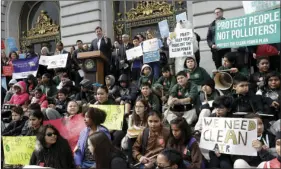  ?? PHOTO/JEFF CHIU ?? Acting San Francisco Mayor Mark Farrell, at podium, speaks at a rally for clean energy in San Francisco on Wednesday. AP