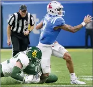  ?? MATTHEW HINTON — THE ASSOCIATED PRESS ?? Mississipp­i quarterbac­k Matt Corral, right, is tackled by Baylor defensive tackle Cole Maxwell, bottom, and linebacker Matt Jones, left, during Saturday’s Sugar Bowl. Corral, a project first-round draft pick, was injured in the first-quarter play and sat out the remainder of the game.