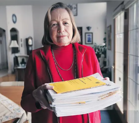  ?? DAN JANISSE ?? Gay Viecelli displays a stack of documents related to her issues with Tarion for a home she owned a decade ago. Tarion is a company that regulates new builders and provides warranties for new homes.