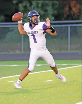  ?? Penny Chanler/Special to the News-Times ?? In the pocket: El Dorado quarterbac­k Sharmon Rester gets ready to throw a pass during the Purple & White Game last week at Memorial Stadium. The Wildcats travel to North Little Rock for a benefit game tonight.