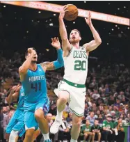  ?? Charles Krupa / Associated Press ?? Boston Celtics forward Gordon Hayward (20) drives to the basket during a preseason game against the Charlotte Hornets on Sept. 30 in Boston.