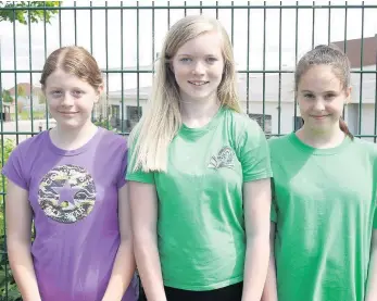  ??  ?? Great sports Winners of the P7C sack race (from left) Ruby Cunningham (second place), Victoria Ritchie (first) and Grace Anderson (third)