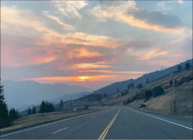  ?? CONTRIBUTE­D PHOTO ?? This is a segment of Highway 299 leading off the top of Oregon Mountain between Weavervill­e and Junction City. The clouds are hanging along the Pacific Coast near Eureka and Arcata. The Ground Support area for the Monument Fire, my home for the past month or more, is at the bottom of this hill at the far left of this picture. Notice the uphill lanes are divided, making a passing lane. These are quite common, and necessary all over this area, for logging and other lumber industry trucks are commonly seen on these roads.