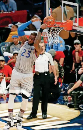  ?? [AP PHOTO] ?? The Eastern Conference’s LeBron James of the Cleveland Cavaliers makes a backward dunk during the NBA All-Star Game on Sunday night at Smoothie King Center in New Orleans.