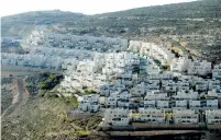  ?? (Ammar Awad/Reuters) ?? HOUSES RING a hillside of Givat Ze’ev in the West Bank last February.