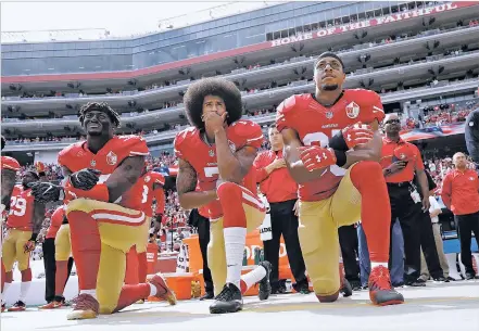  ?? ASSOCIATED PRESS FILE PHOTOS ?? ABOVE: From left, San Francisco 49ers outside linebacker Eli Harold, quarterbac­k Colin Kaepernick and safety Eric Reid kneel during the national anthem before an Oct. 2 game against the Dallas Cowboys in Santa Clara, Calif. What started as a protest...