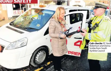  ??  ?? Cab checks PC Geoff Robertson and Donna Scobie from South Ayrshire Council