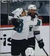  ?? STACY BENGS — THE ASSOCIATED PRESS ?? San Jose’s Mario Ferraro, left, hugs teammate Brent Burns in celebratio­n after Burns scored a goal in the third period against the Minnesota Wild on Sunday. San Jose won 5-3.