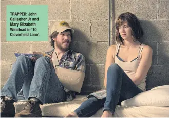  ??  ?? TRAPPED: John Gallagher Jr and Mary Elizabeth Winstead in ‘10 Cloverfiel­d Lane’.