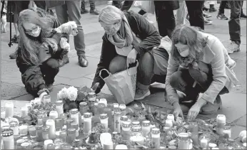  ?? OLIVER DIETZE/DPA ?? Flowers are placed and candles are lit Wednesday in Trier, Germany, in memory of five people killed Tuesday when a man sped an SUV through a pedestrian zone. One of those killed was a 91⁄ 2- week old girl. The unidentifi­ed 51-year-old driver is being investigat­ed for five counts of murder and 18 counts of attempted murder. Police say a motive remains unknown.