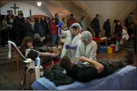  ?? VADIM GHIRDA — THE ASSOCIATED PRESS ?? People wait in line to donate blood for wounded Ukrainian personnel during an event in the basement of the St. Nicholas Roman Catholic Church in Kyiv, Ukraine, on Tuesday.