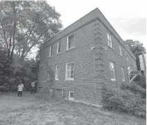  ??  ?? Architects say the derelict two-storey, red brick building at 231 Cobourg St. is slouching to one side and there’s no reasonable way to save it.