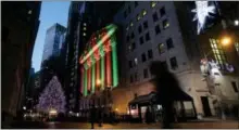  ?? MARK LENNIHAN — THE ASSOCIATED PRESS FILE ?? The New York Stock Exchange is bathed in holiday light in New York.