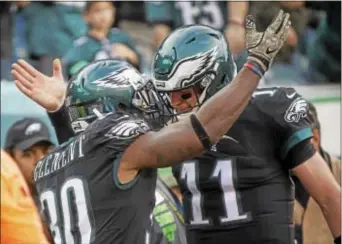  ?? RICK KAUFFMAN — DIGITAL FIRST MEDIA ?? There’s no doubt that quarterbac­k Carson Wentz, here congratula­ting running back Corey Clement after a touchdown in a 51-23 pasting of the Broncos Sunday, has fueled the Eagles’ 8-1 start. But coach Doug Pederson knows — and isn’t afraid to share —...