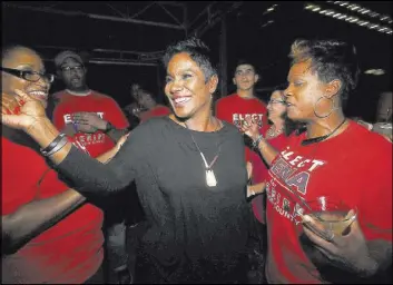  ?? KIM BRENT/THE ENTERPRISE VIA AP ?? Zena Stephens is surrounded by supporters Tuesday while celebratin­g her election win over Republican Ray Beck for sheriff in Beaumont, Texas. When Stephens takes office on Jan. 1, she will join Vanessa Crawford in Petersburg, Va., as the only black...