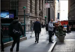  ?? (Bloomberg News (WPNS)/Michael Nagle) ?? Pedestrian­s walk along Wall Street near the New York Stock Exchange in New York in 2018.